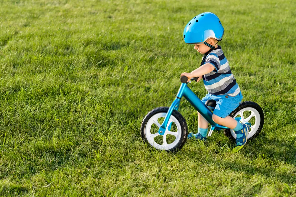 A boy on a balance Bike
