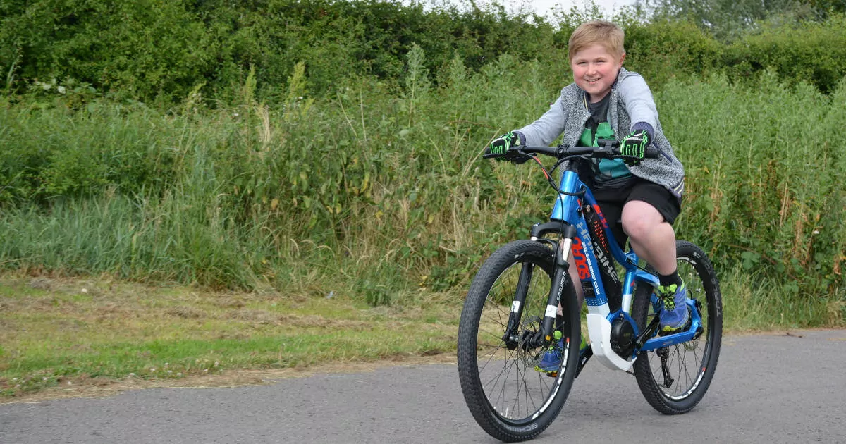 Physically challenged Kid riding an e-bike